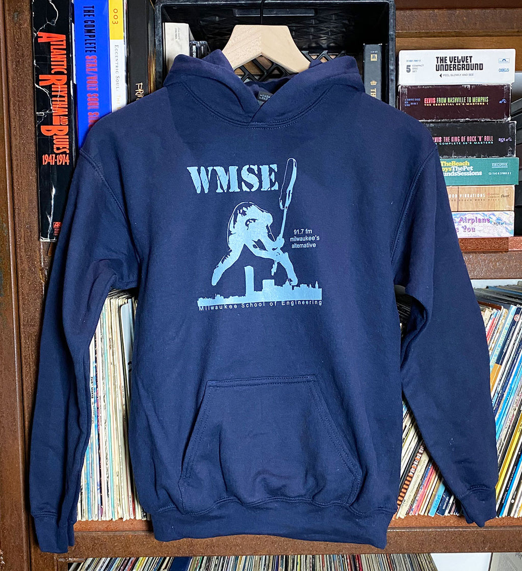 Navy blue hoodie with 'WMSE' logo on a rack with books in the background