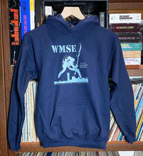 Load image into Gallery viewer, Navy blue hoodie with &#39;WMSE&#39; logo on a rack with books in the background