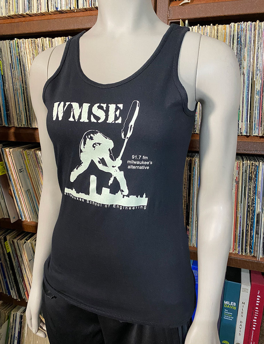 Black tank top with white graphic and text on a mannequin in front of vinyl stacks.