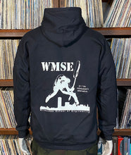 Load image into Gallery viewer, Black hoodie with &#39;WMSE&#39; logo on the back, worn by a person in front of vinyl stacks.