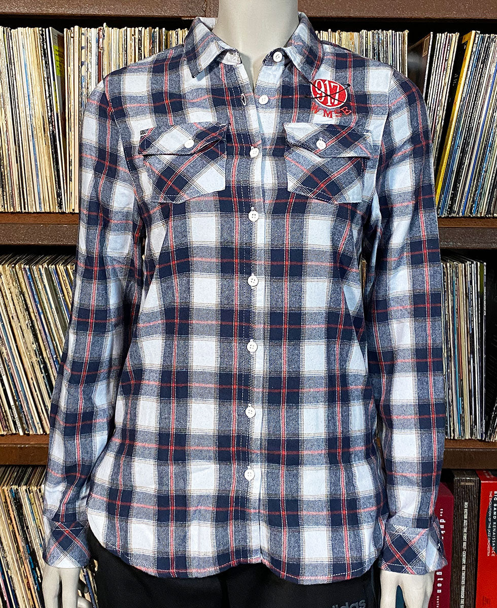 Plaid shirt on a mannequin in front of a bookshelf