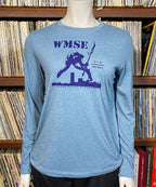 Blue long-sleeve shirt with graphic design on a mannequin against a bookshelf background