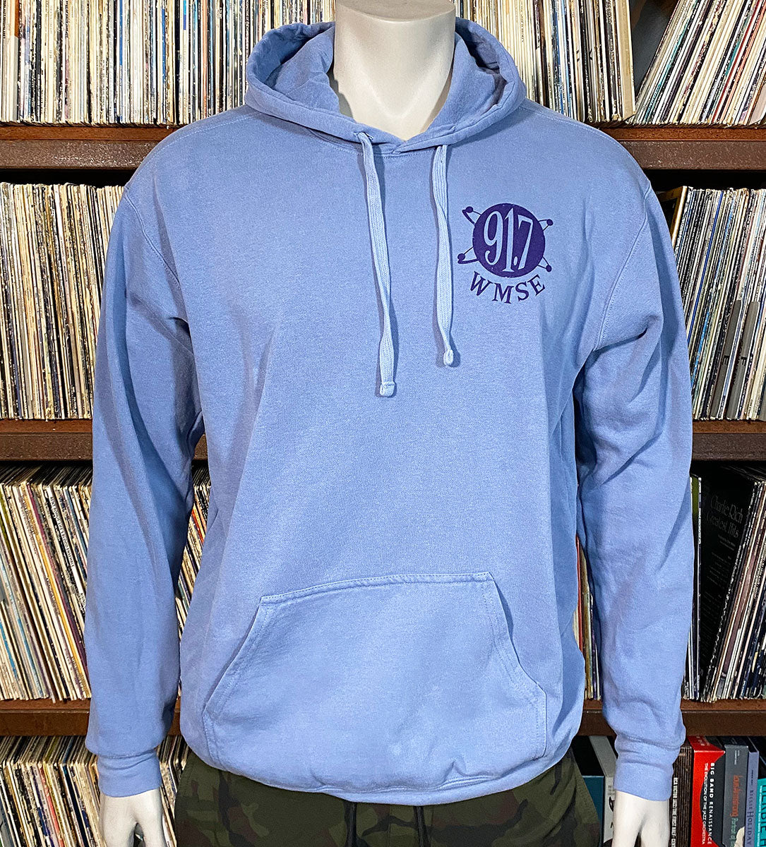 Blue hoodie with a logo on a mannequin in front of a record album collection.